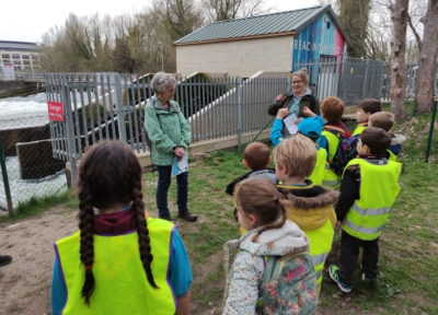 Two Reading Hydro volunteers giving a talk to a local Beaver group in front of the turbines